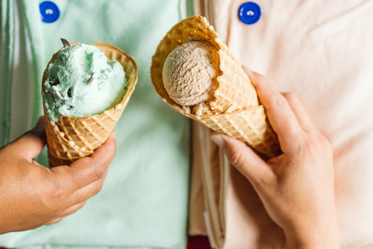 two ice cream cones held over towels