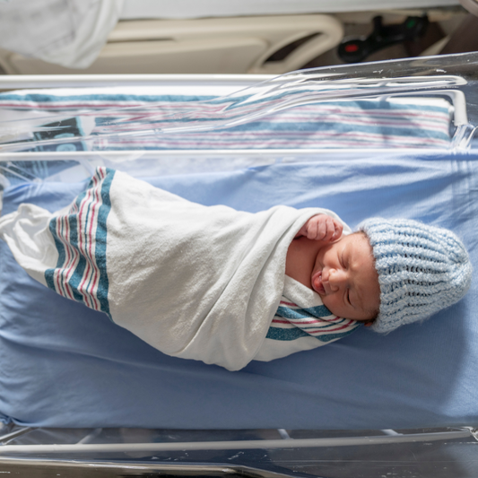 Newborn baby in a hospital crib